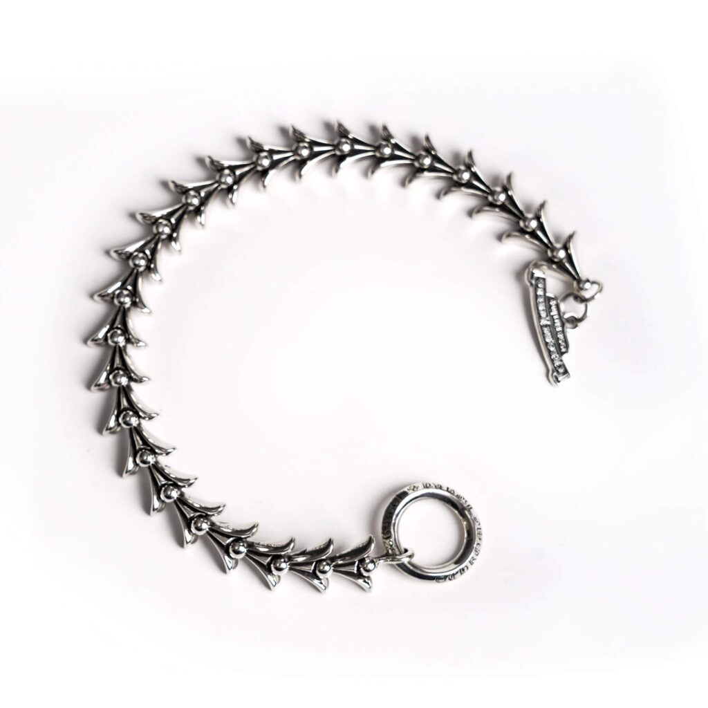 authentic chrome hearts crosstail bracelet with logo tag - premium designer jewelry front view